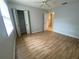 The bright bedroom boasts hardwood floors, with a view of the closet, and ensuite bathroom at 2131 Ridge S Rd # 86, Largo, FL 33778
