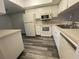 A bright kitchen features appliances, ample cabinet space, and a modern gray-tone floor at 2131 Ridge S Rd # 86, Largo, FL 33778