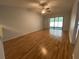 The bright living room boasts hardwood floors, a ceiling fan, and access to the patio at 2131 Ridge S Rd # 86, Largo, FL 33778