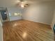 The bright living room boasts hardwood floors, a ceiling fan, and access to the kitchen at 2131 Ridge S Rd # 86, Largo, FL 33778