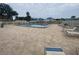 Community pool area with lounge chairs and umbrellas, perfect for relaxation at 2131 Ridge S Rd # 86, Largo, FL 33778