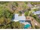 Aerial shot of a home featuring a screened pool, showcasing its spacious layout and well-maintained landscaping at 22002 Darley Pl, Land O Lakes, FL 34639