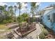 Beautifully landscaped backyard with a paved walkway leading to the screened in pool at 22002 Darley Pl, Land O Lakes, FL 34639
