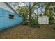Backyard featuring the home's exterior and a storage shed at 22002 Darley Pl, Land O Lakes, FL 34639