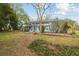 Expansive backyard featuring manicured landscaping and a screened-in pool at 22002 Darley Pl, Land O Lakes, FL 34639