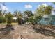 A relaxing backyard setting with a screened-in pool area complemented by trees and planting beds at 22002 Darley Pl, Land O Lakes, FL 34639