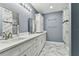 This bathroom features a double sink, a shower, and marble flooring at 22002 Darley Pl, Land O Lakes, FL 34639