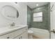 Bathroom with white vanity, oval mirror and shower and tub combo at 22002 Darley Pl, Land O Lakes, FL 34639