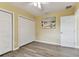 Bedroom with hardwood floors, ceiling fan, and closet space at 22002 Darley Pl, Land O Lakes, FL 34639