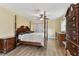 This bedroom features natural light, a ceiling fan, and hardwood flooring at 22002 Darley Pl, Land O Lakes, FL 34639