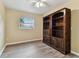 Bedroom with ceiling fan, hardwood floors, and a built-in bookcase at 22002 Darley Pl, Land O Lakes, FL 34639