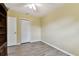 Bedroom featuring neutral walls, wood floors, ceiling fan, and a closet at 22002 Darley Pl, Land O Lakes, FL 34639