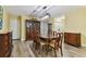 Traditional dining room featuring a wood table, chairs with patterned cushions, and matching wooden storage cabinets at 22002 Darley Pl, Land O Lakes, FL 34639