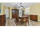 Well-lit dining room showcasing wood floors, a classic dining set, and ample space for entertaining at 22002 Darley Pl, Land O Lakes, FL 34639