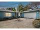 Charming home with a two-car garage, well-kept landscaping, and lush green trees at 22002 Darley Pl, Land O Lakes, FL 34639