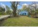 Lush front yard with blue home as backdrop at 22002 Darley Pl, Land O Lakes, FL 34639