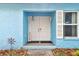 Charming front porch with double doors, a 'Welcome' sign, and whimsical decor at 22002 Darley Pl, Land O Lakes, FL 34639