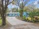 Charming one-story home with well-manicured front yard, mature trees, and long driveway at 22002 Darley Pl, Land O Lakes, FL 34639