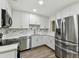 Bright kitchen featuring white cabinets, stainless steel appliances, and a modern marble backsplash at 22002 Darley Pl, Land O Lakes, FL 34639