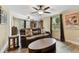 Inviting living room with a leather sofa, hardwood-style floors, and large windows at 22002 Darley Pl, Land O Lakes, FL 34639