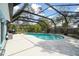Screened-in kidney-shaped pool and spacious patio area at 22002 Darley Pl, Land O Lakes, FL 34639