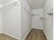 Walk-in closet with wood floors and shelving at 22002 Darley Pl, Land O Lakes, FL 34639