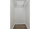 Walk-in closet with wood floors and shelving at 22002 Darley Pl, Land O Lakes, FL 34639