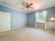 Bedroom featuring neutral carpet, crown moulding, ceiling fan, and a sunny window at 2354 Messenger Cir, Safety Harbor, FL 34695