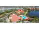 Aerial view of community featuring swimming pool, clubhouse, and lakeside apartments at 2709 Via Cipriani # 532B, Clearwater, FL 33764