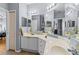Well-lit bathroom features double sinks, marble countertop, decorative mirrors, and a shower/tub combo at 2709 Via Cipriani # 532B, Clearwater, FL 33764