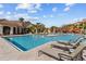 Community pool surrounded by lounge chairs with nearby community buildings at 2709 Via Cipriani # 532B, Clearwater, FL 33764