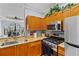 Kitchen with granite counters, stainless appliances, and a view to the living area at 2709 Via Cipriani # 532B, Clearwater, FL 33764