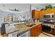 Modern kitchen with granite counters, stainless appliances, and an eat-in bar at 2709 Via Cipriani # 532B, Clearwater, FL 33764