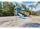 Community playground with a slide, climbing structure, and sand surface for safe play at 2709 Via Cipriani # 532B, Clearwater, FL 33764