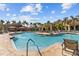 Resort-style pool with cabanas, ample seating, and lush tropical landscaping at 2709 Via Cipriani # 532B, Clearwater, FL 33764