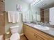 Bathroom with double towels, an oak vanity, and a large mirror at 3001 58Th S Ave # 912, St Petersburg, FL 33712