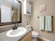 Bathroom features a wood vanity, granite countertop, and a decorative mirror at 3001 58Th S Ave # 912, St Petersburg, FL 33712