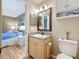 Bathroom with wood vanity and view into a bedroom at 3001 58Th S Ave # 912, St Petersburg, FL 33712
