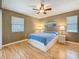 Bedroom featuring light-wood floors, two windows, and an art piece at 3001 58Th S Ave # 912, St Petersburg, FL 33712