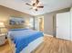 Bedroom with light-wood floors, ceiling fan, and an ensuite bathroom at 3001 58Th S Ave # 912, St Petersburg, FL 33712