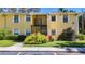 Inviting condo exterior with well-maintained landscaping, sidewalk, and charming architectural details at 3001 58Th S Ave # 912, St Petersburg, FL 33712