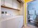 Bright laundry area includes a washer, dryer, and white cabinets with easy access to the bathroom at 3001 58Th S Ave # 912, St Petersburg, FL 33712