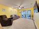 Spacious living area featuring sliding door access to balcony and a ceiling fan at 3001 58Th S Ave # 912, St Petersburg, FL 33712