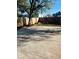 Backyard patio with wood fence, concrete, and large mature tree at 4108 55Th N Ave, St Petersburg, FL 33714
