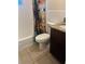 Well-maintained bathroom with a vibrant floral shower curtain and a granite vanity top at 4108 55Th N Ave, St Petersburg, FL 33714