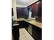 Kitchen boasts granite countertops, stainless steel appliances, and dark wood cabinets at 4108 55Th N Ave, St Petersburg, FL 33714