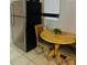 Eat-in kitchen area featuring a stainless steel refrigerator and a cozy breakfast nook with a wooden table at 4108 55Th N Ave, St Petersburg, FL 33714