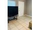 Open living space with tiled floors featuring a TV and storage trunk at 4108 55Th N Ave, St Petersburg, FL 33714