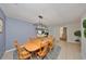 Cozy dining space featuring a wood table, six chairs, and a modern light fixture at 4152 Gerry Ln, Land O Lakes, FL 34638