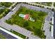 Wide aerial view of the condo community featuring pool, landscaping, common area, and parking at 4715 Bay Ne St # 323, St Petersburg, FL 33703